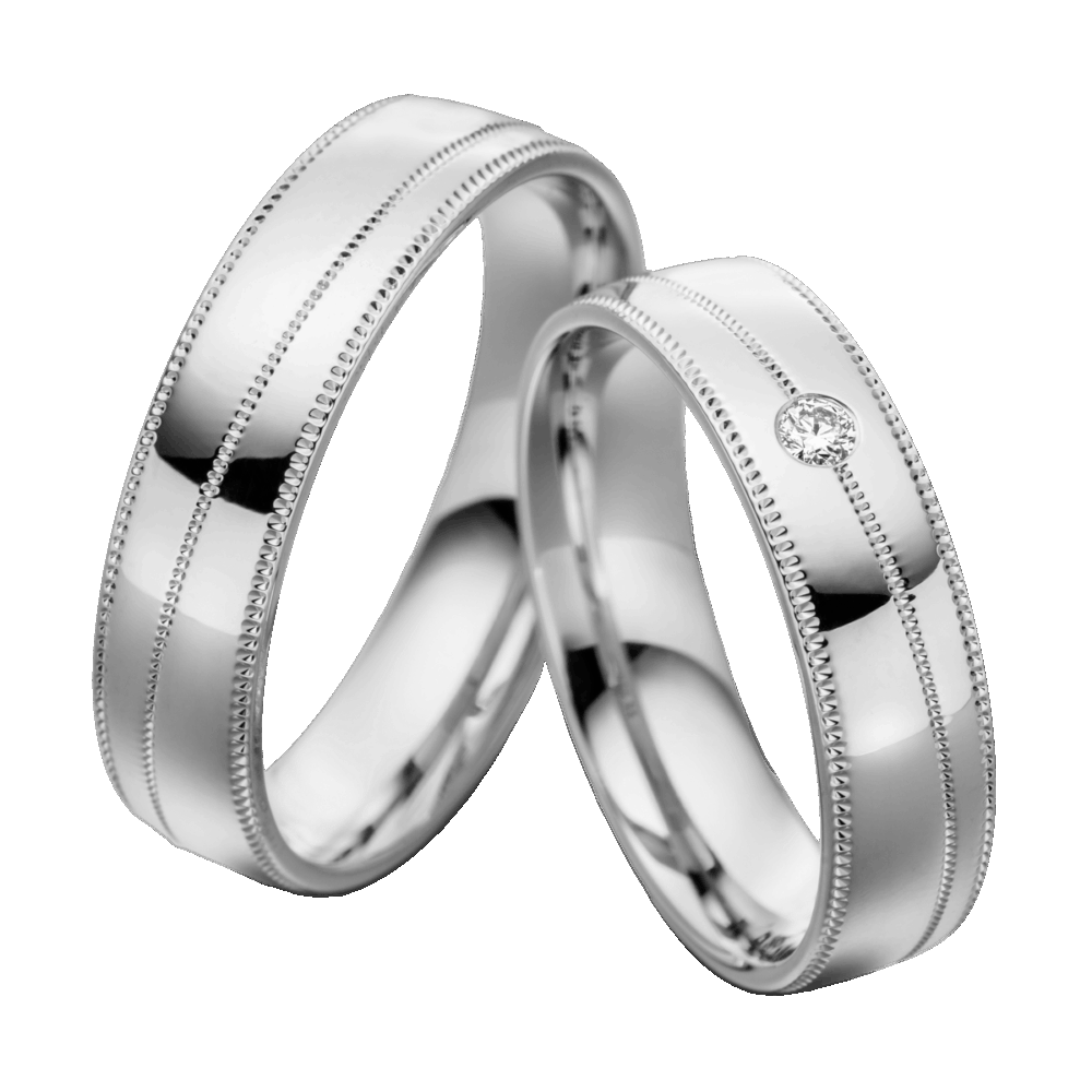 Elegante Weißgold-Trauringe mit diagonaler Millegriffes-Gravur und funkelndem Brillant im Damenring