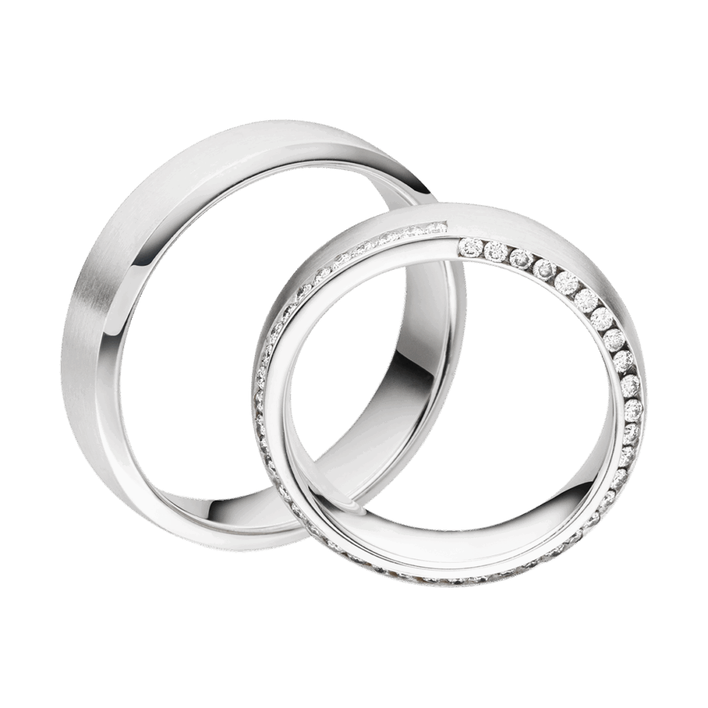 Platinringe mit feiner Mattierung, polierter Kante und spiralförmig gesetzten Brillanten im Damenring