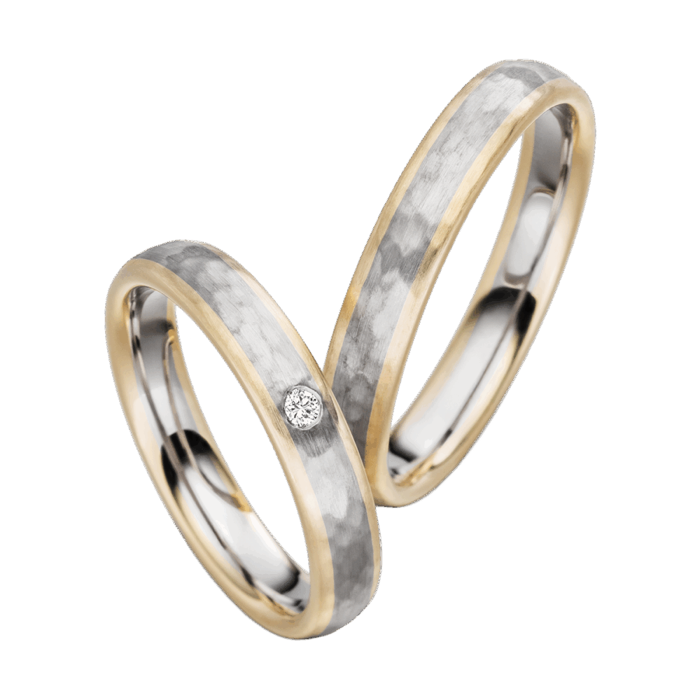 Platin-Gelbgold-Trauringe mit charakteristischer Hammerschlagtextur und brillantgefasstem Highlight im Damenring