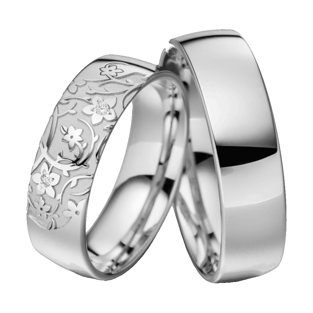 Weißgoldene Trauringe Wüstenblume mit polierter Oberfläche, sandmatter Gravur und diamantbesetzten Blütenornamenten